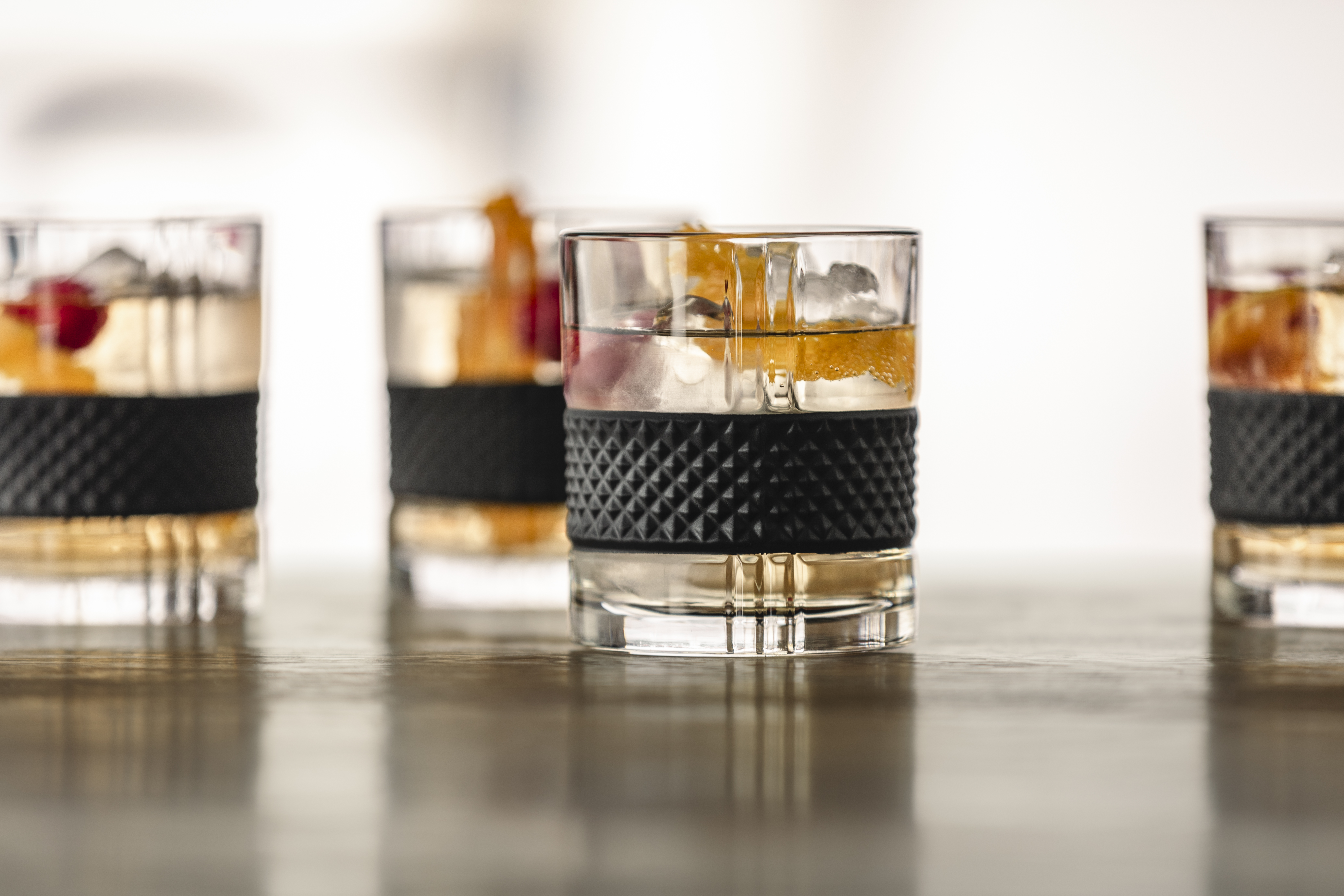 Whisky glasses filled with drink and fruit