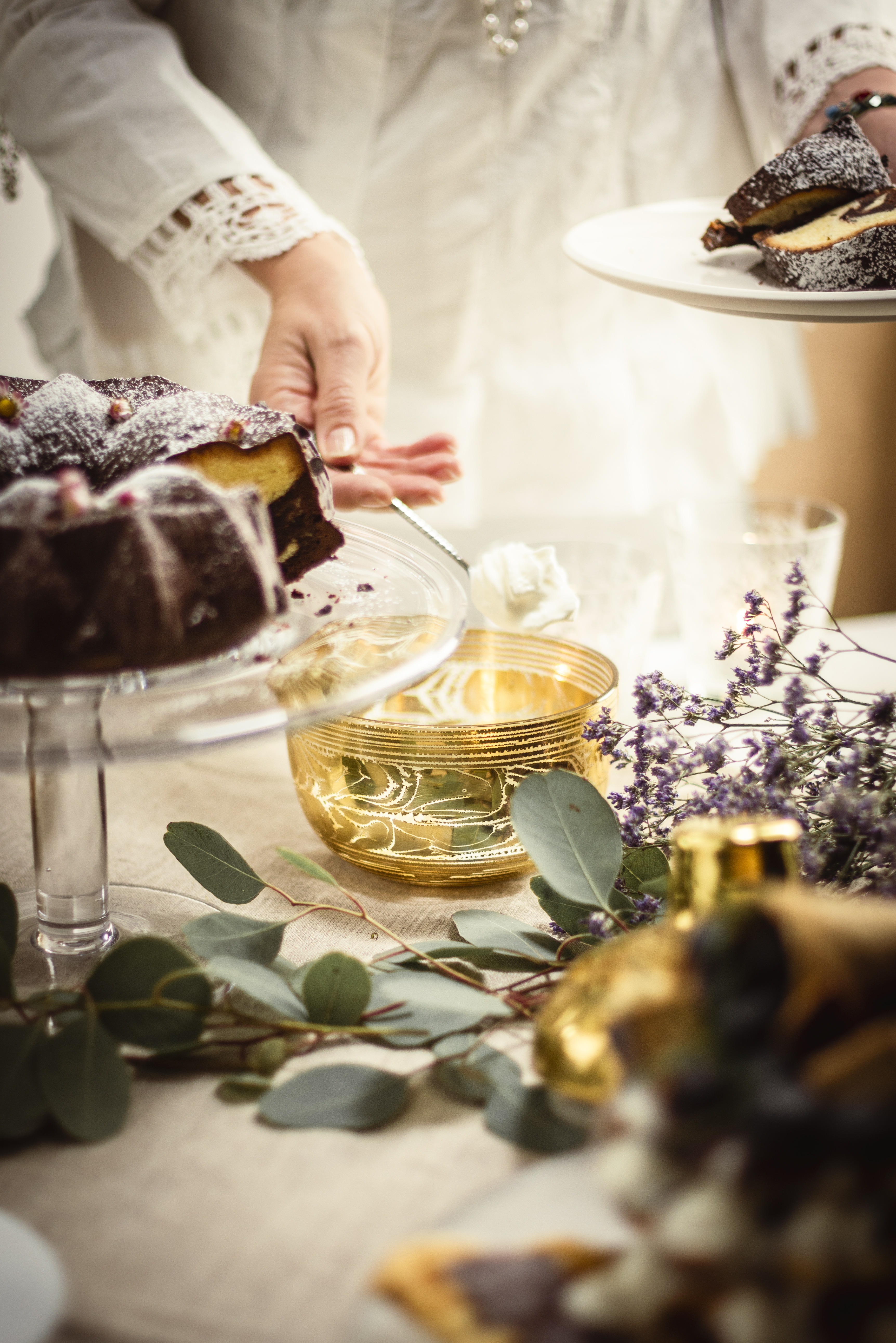 Cake on a beautifully laid table with a golden candy box