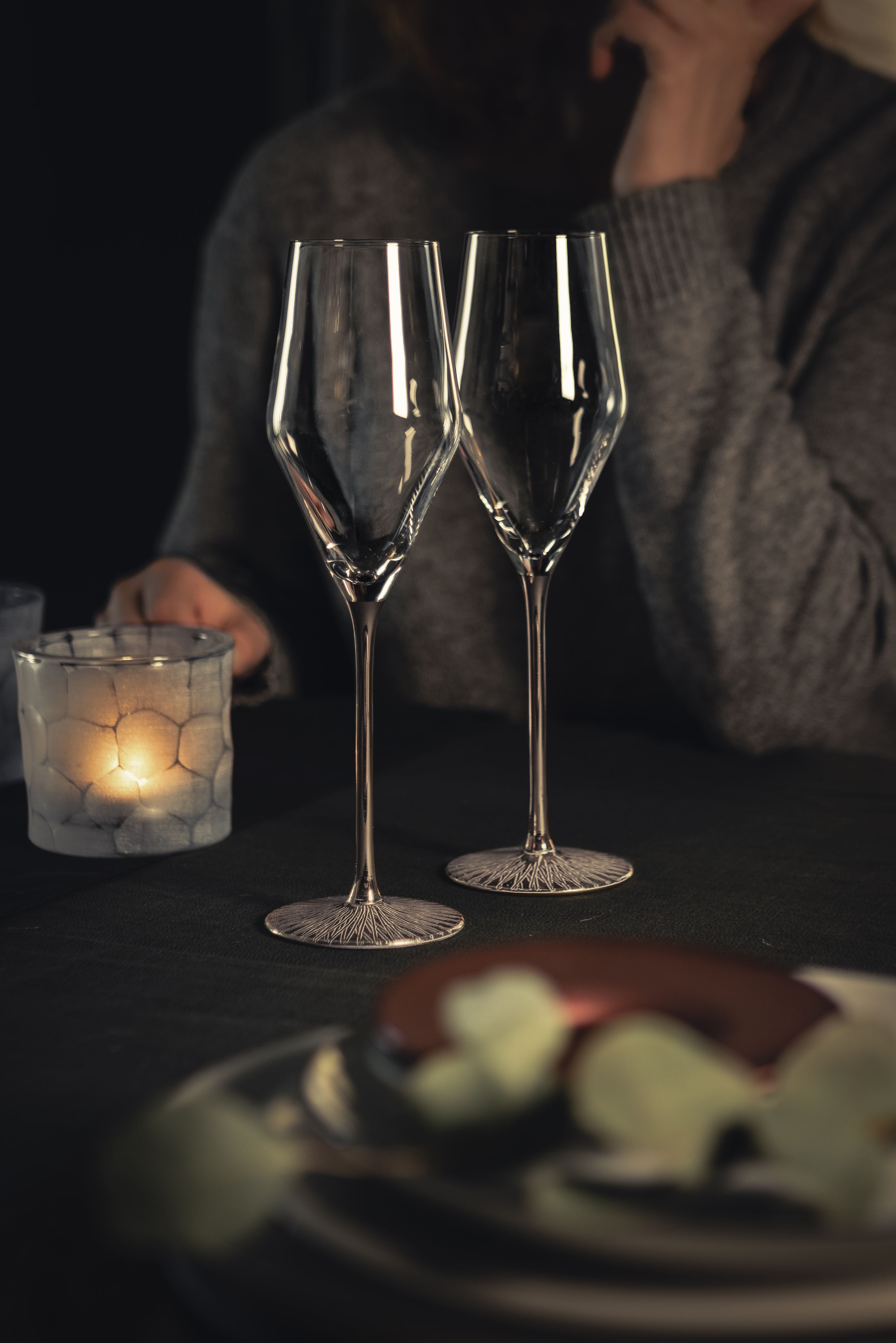 Two platinum-coloured champagne glasses on table