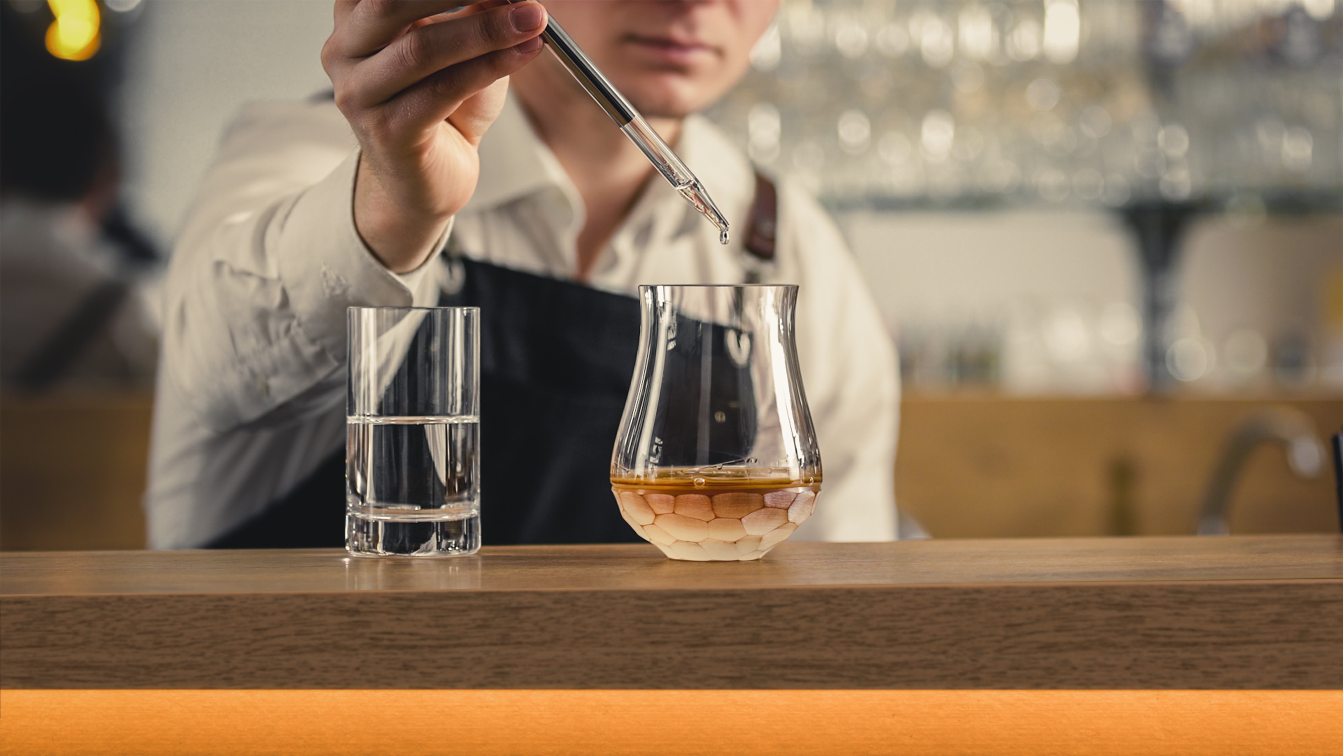 Water is dripped into a whisky glass with a pipette