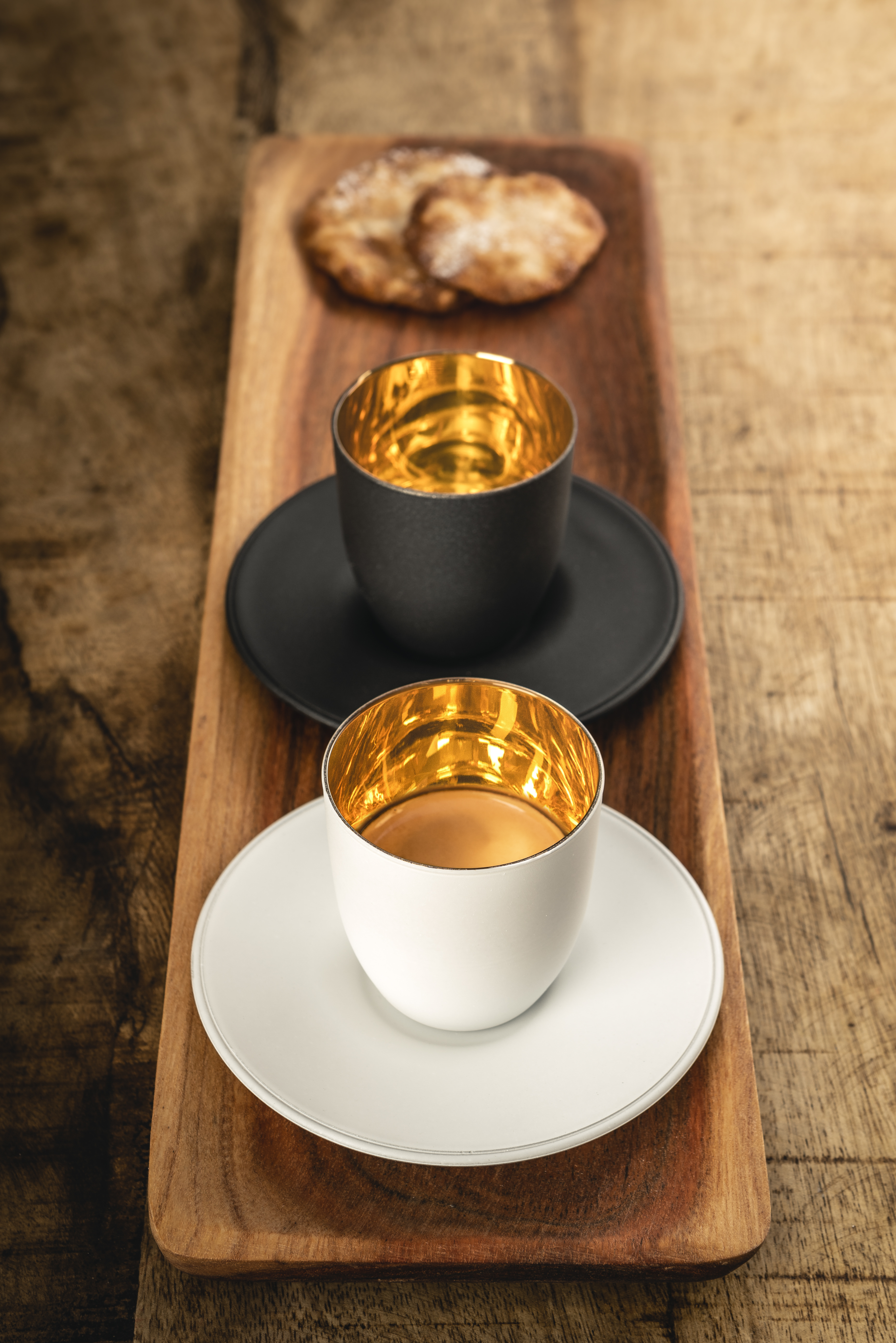 White and black Cosmo Gold espresso glass on wooden tray