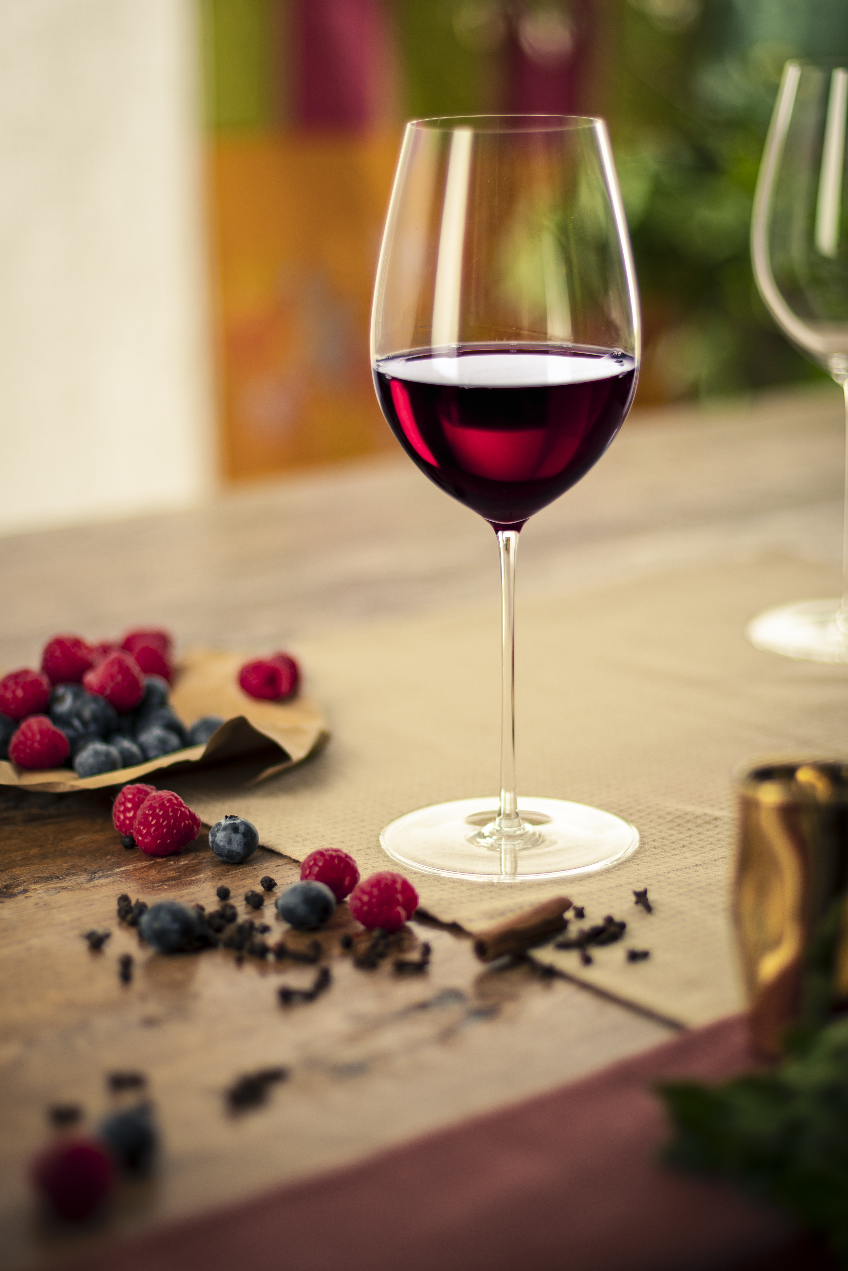 Red wine glass with forest fruits on a table