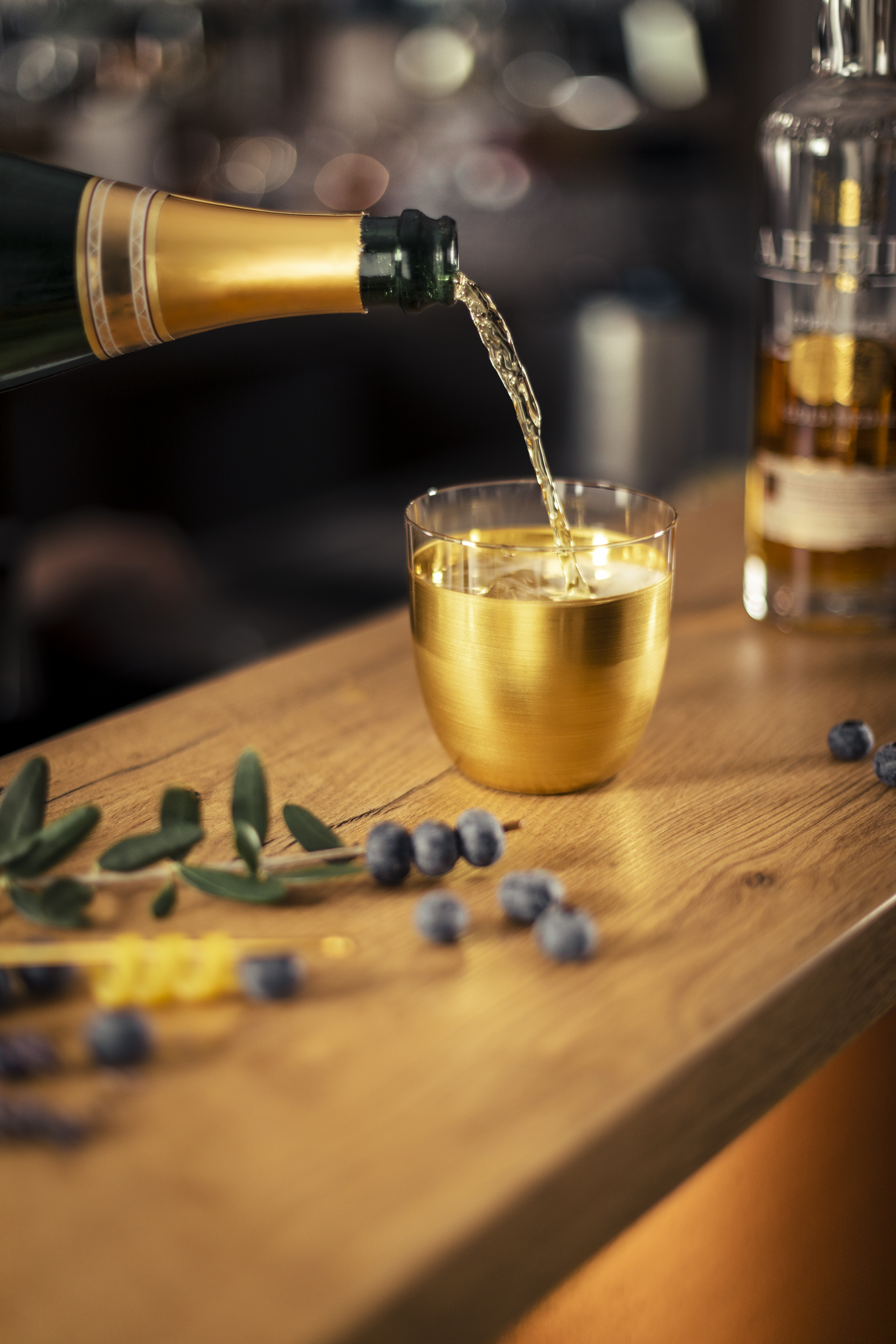 Champagne being poured into Cosmo Gold cups