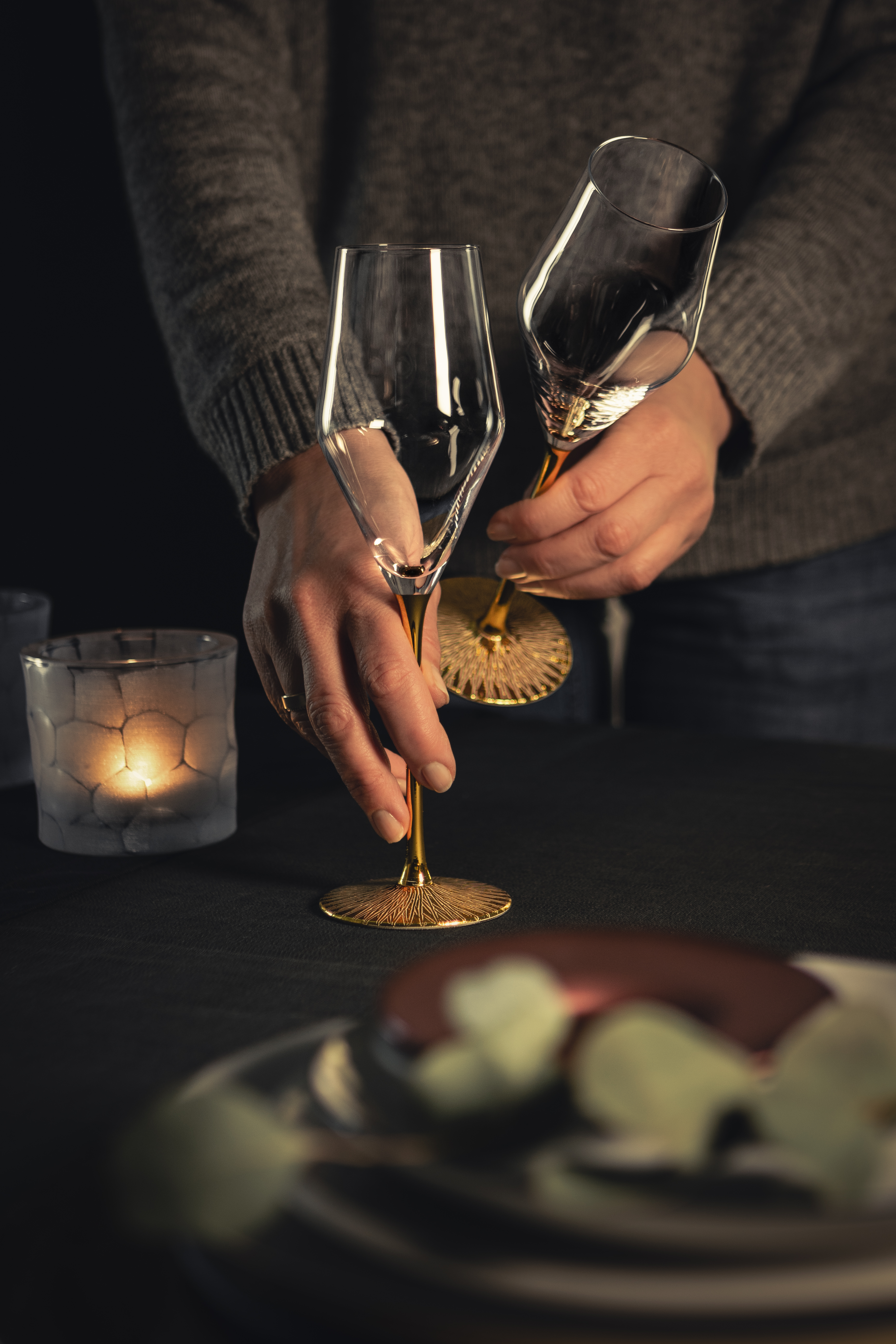 Two champagne glasses placed on table
