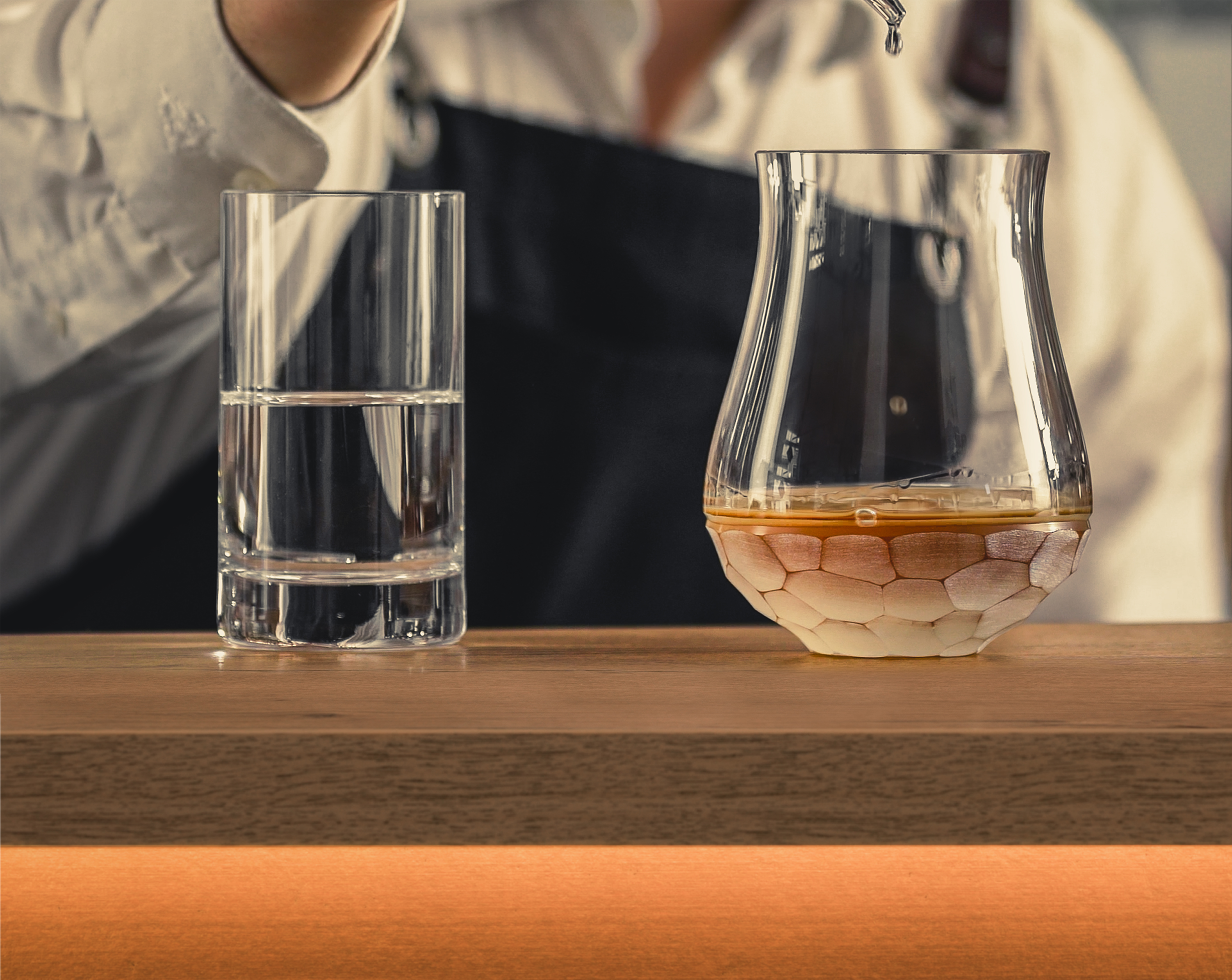 Water is dripped into a whisky glass with a pipette