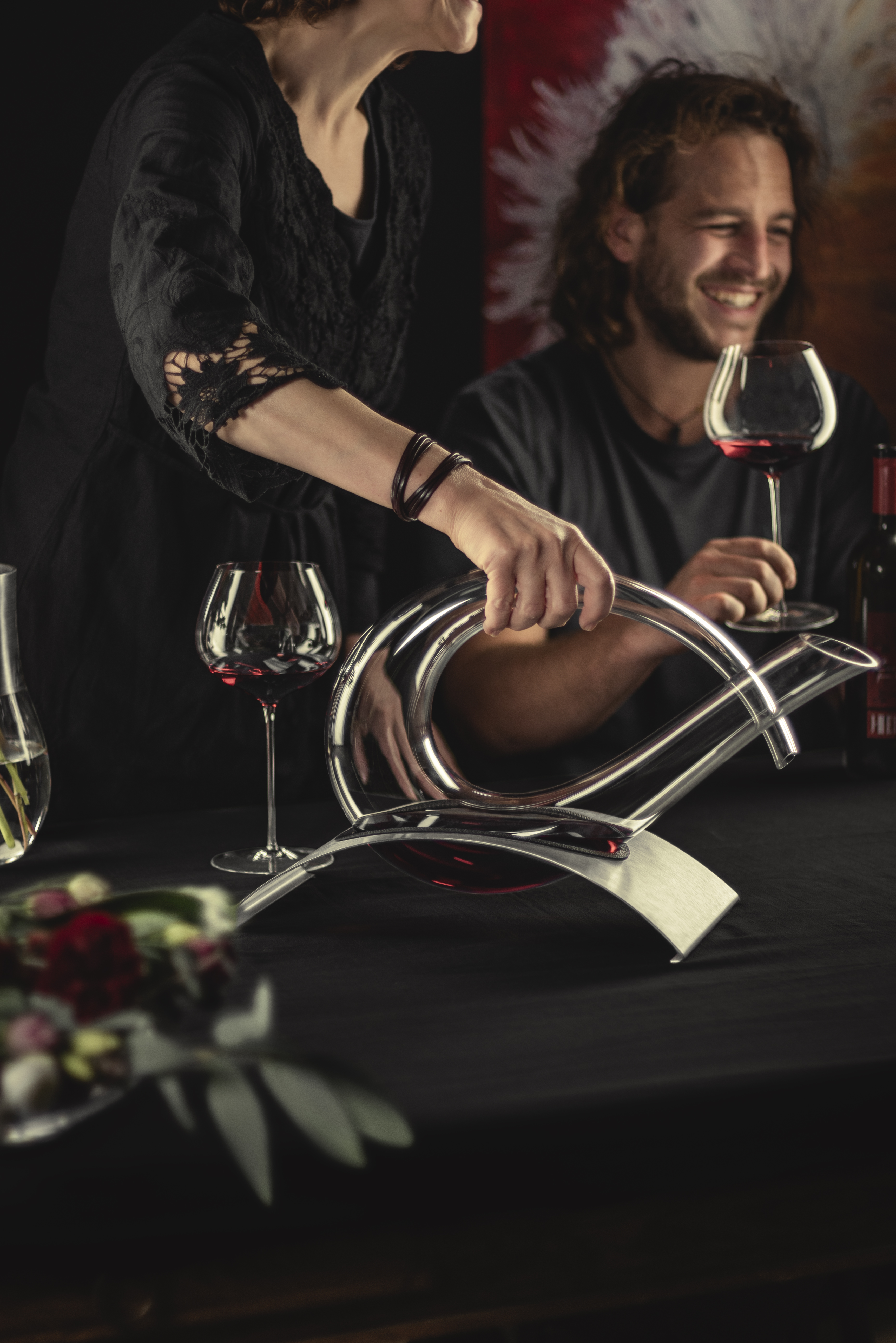 Two people sitting at a table drinking wine