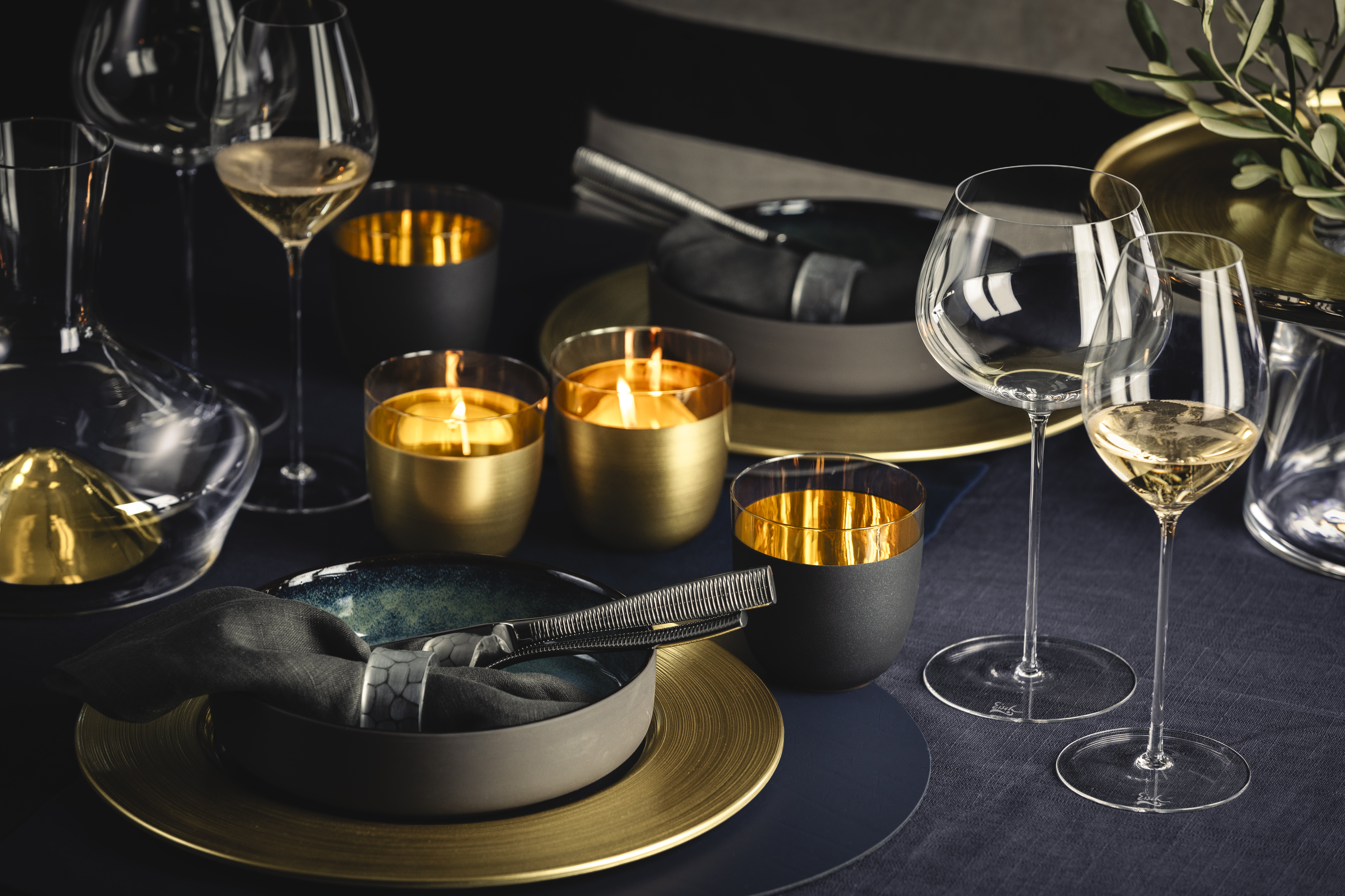 Table scene with gold/black glasses and black plates