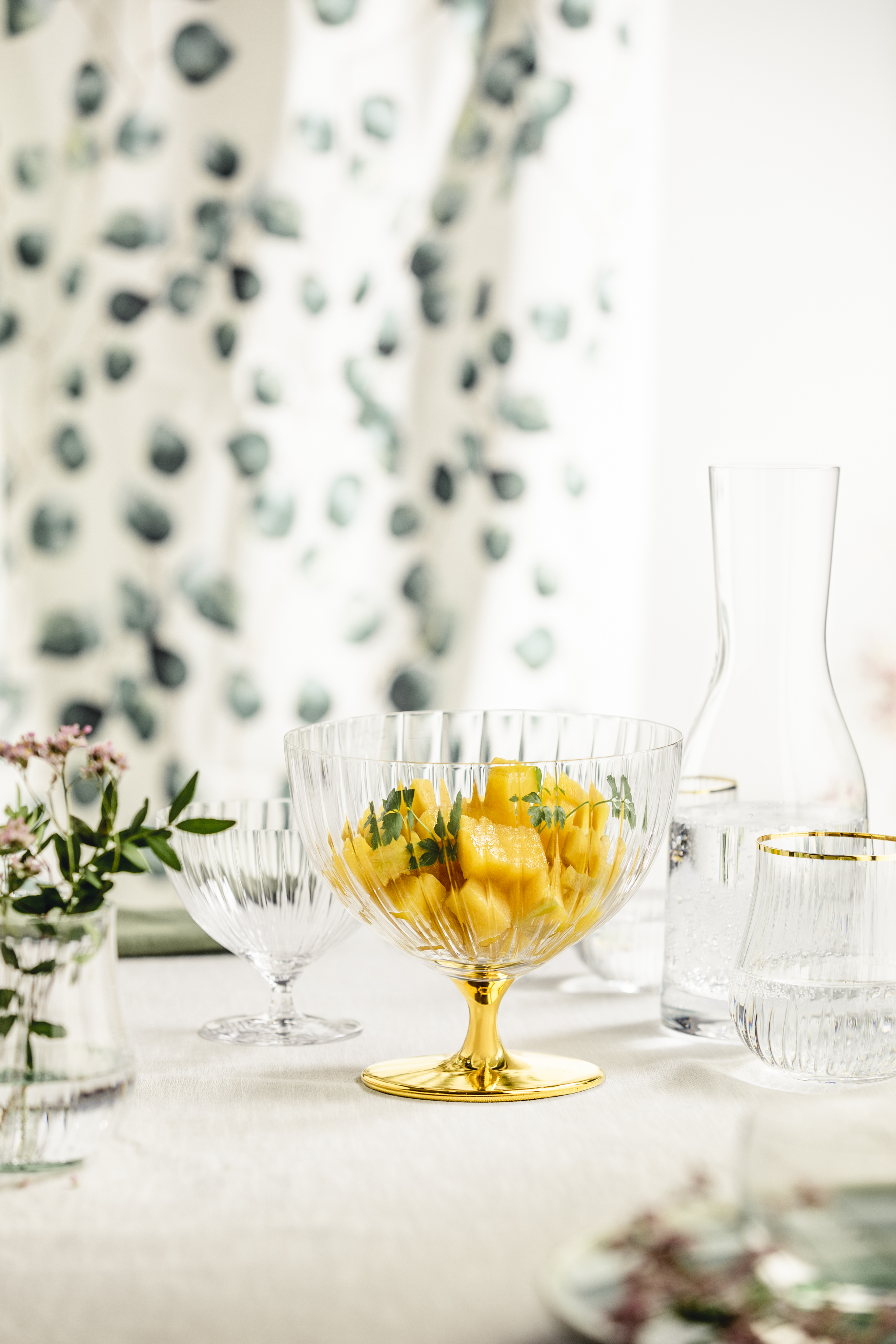 Dessert bowl on a stand with carafe on a spring-like table