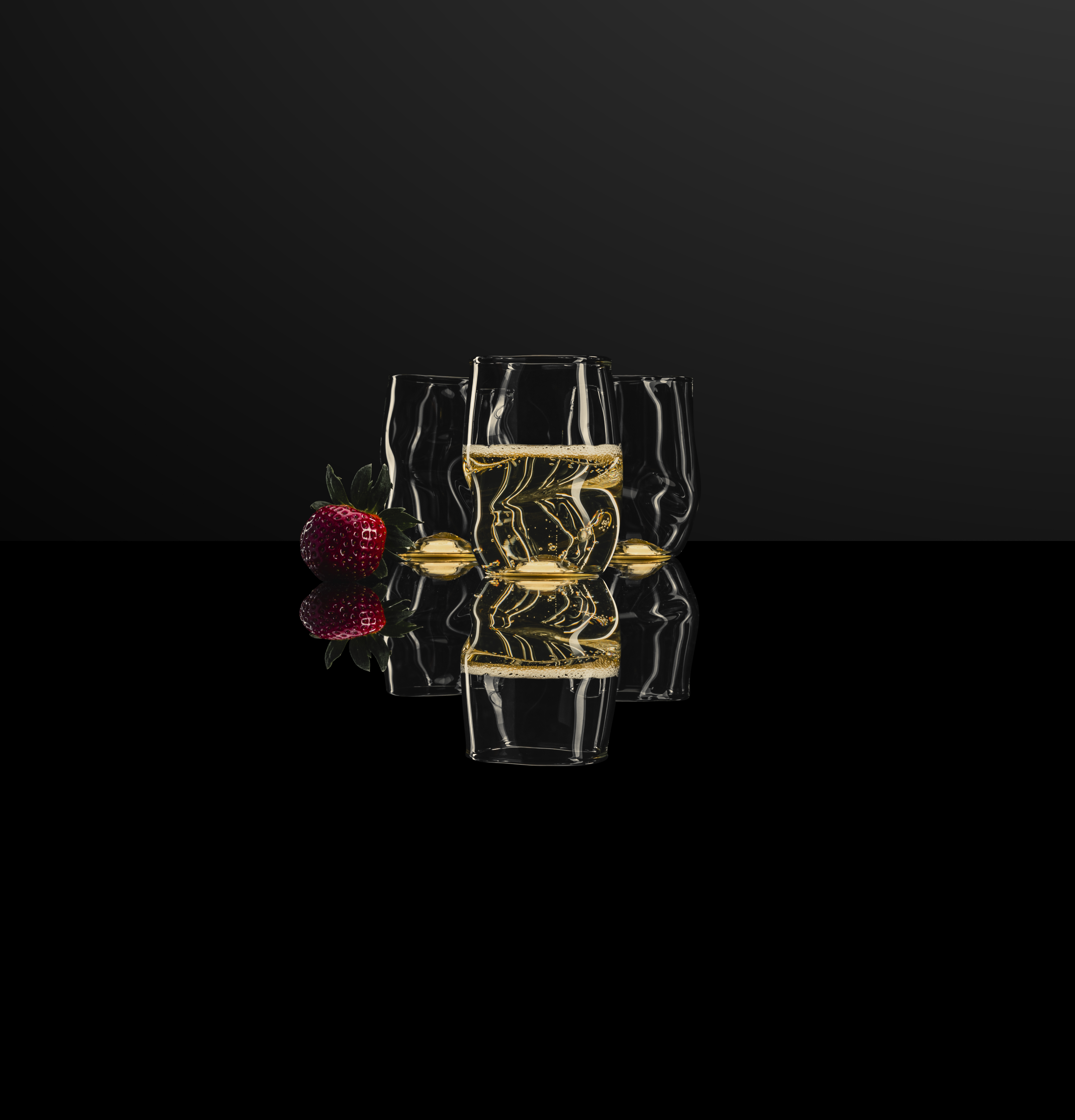 Three Unik mugs against a black background