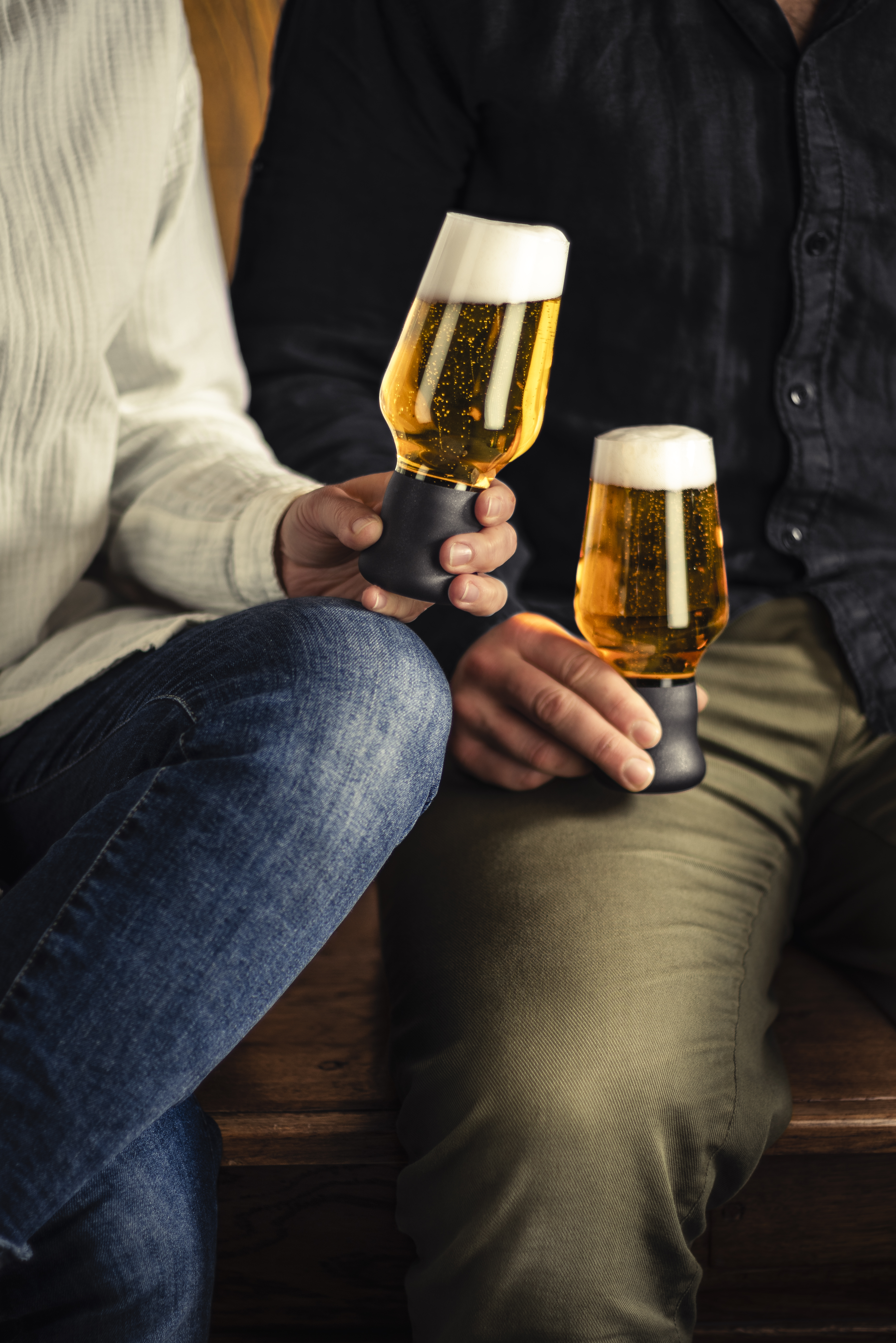 Two people holding craft beer mugs in their hands