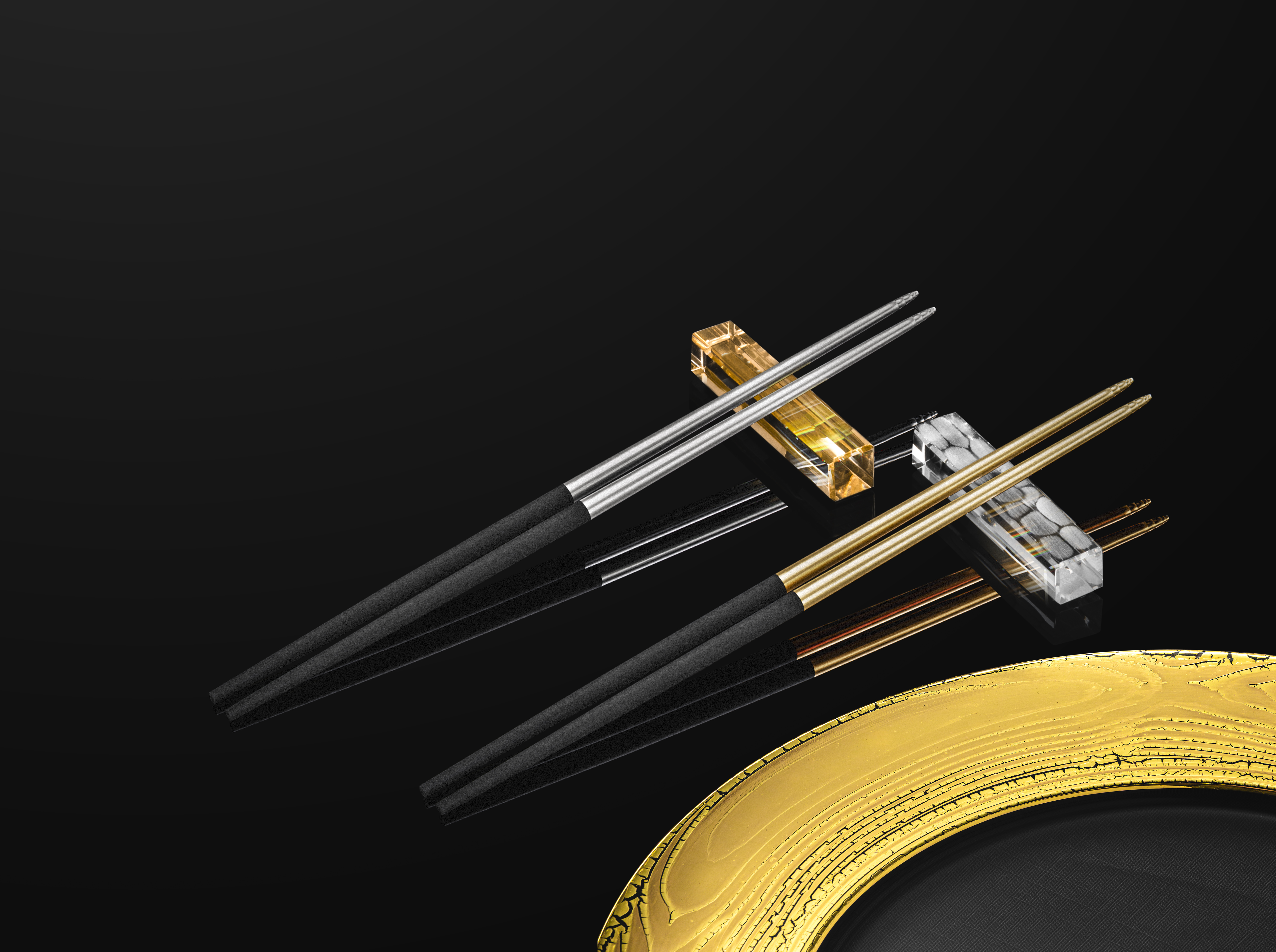 4 elegant chopsticks on knife rest next to golden plate