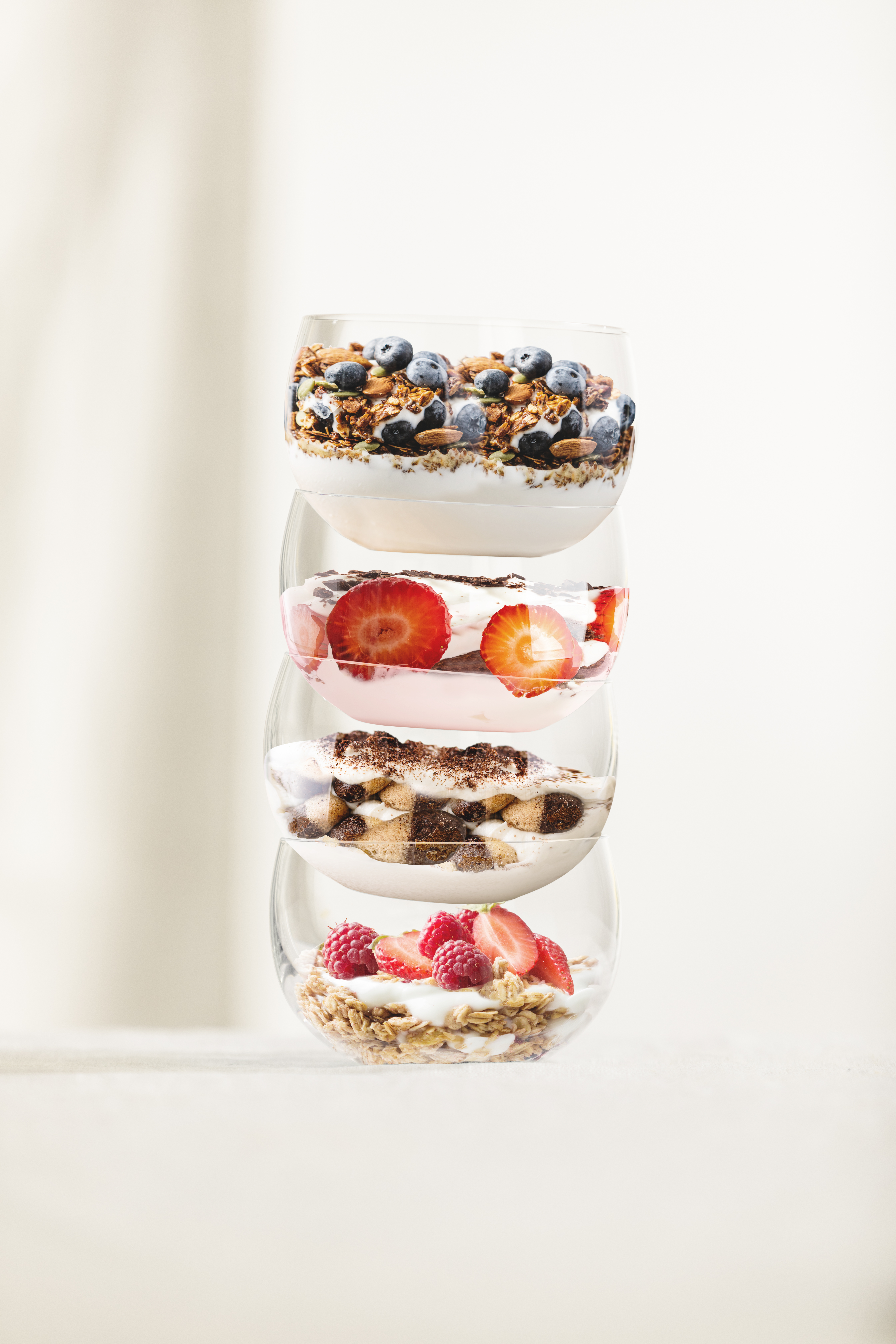 4 colourful filled dessert bowls stacked