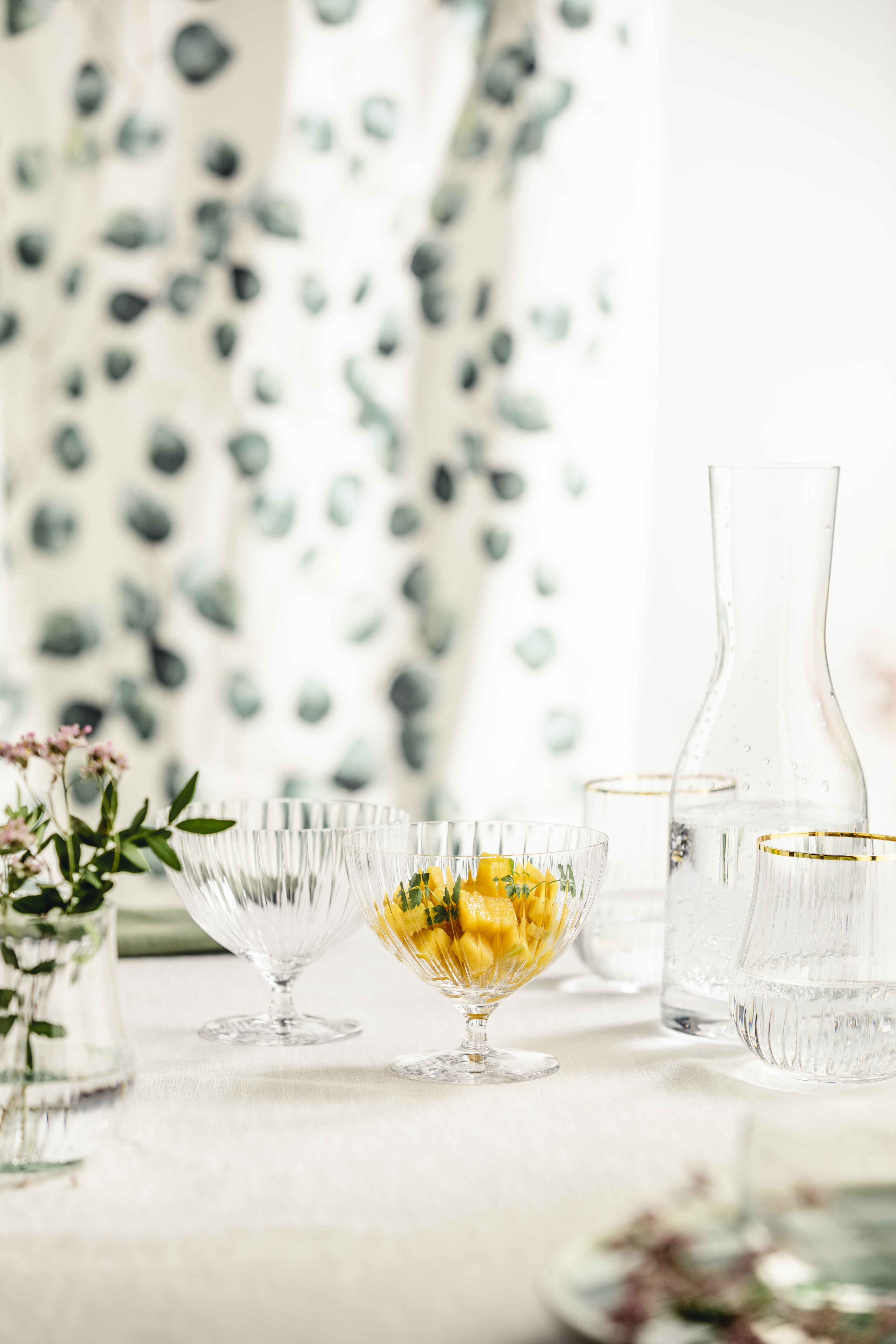 Dessert bowl on a stand with carafe on a spring-like table