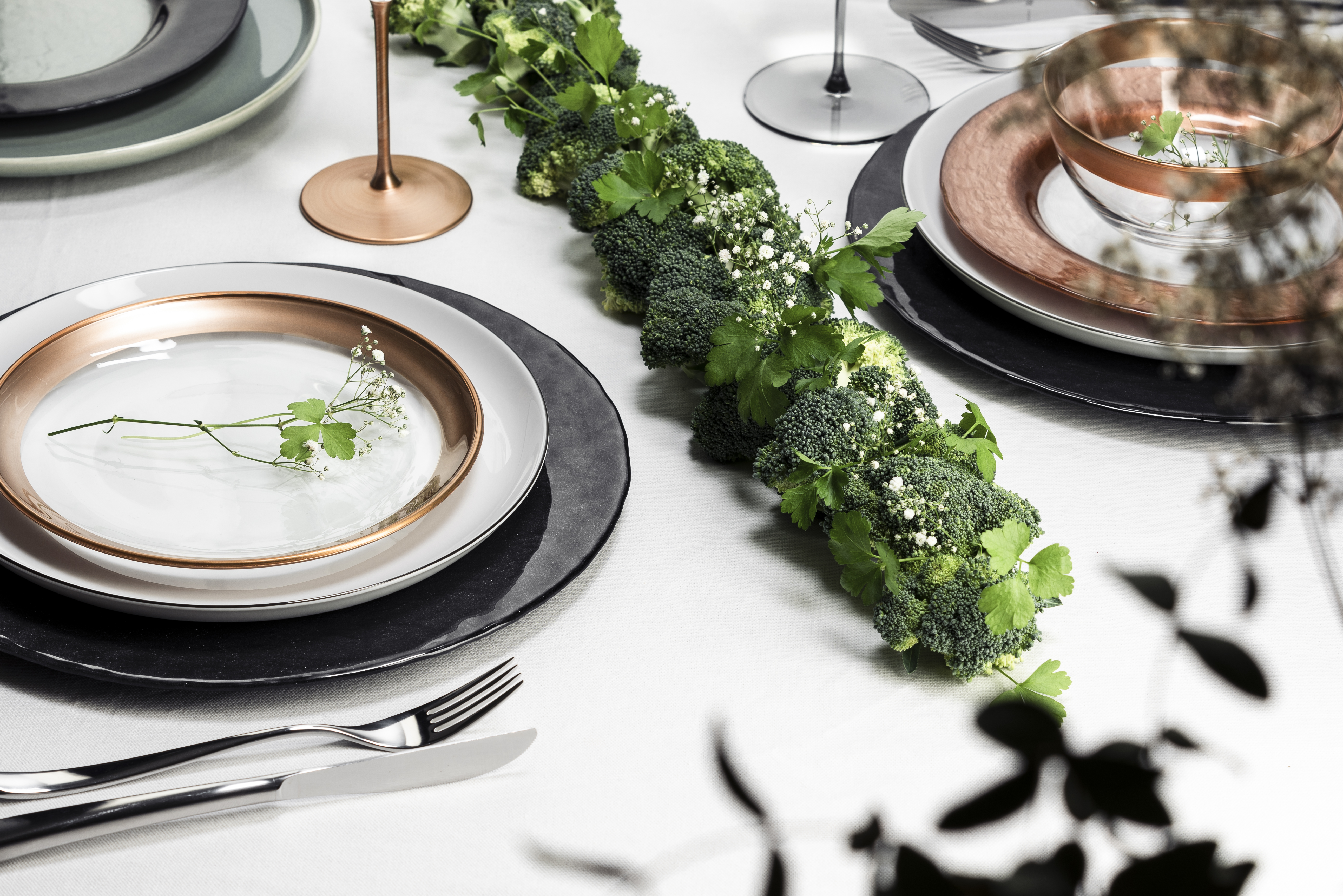 Table laid in copper tones with green table decorations