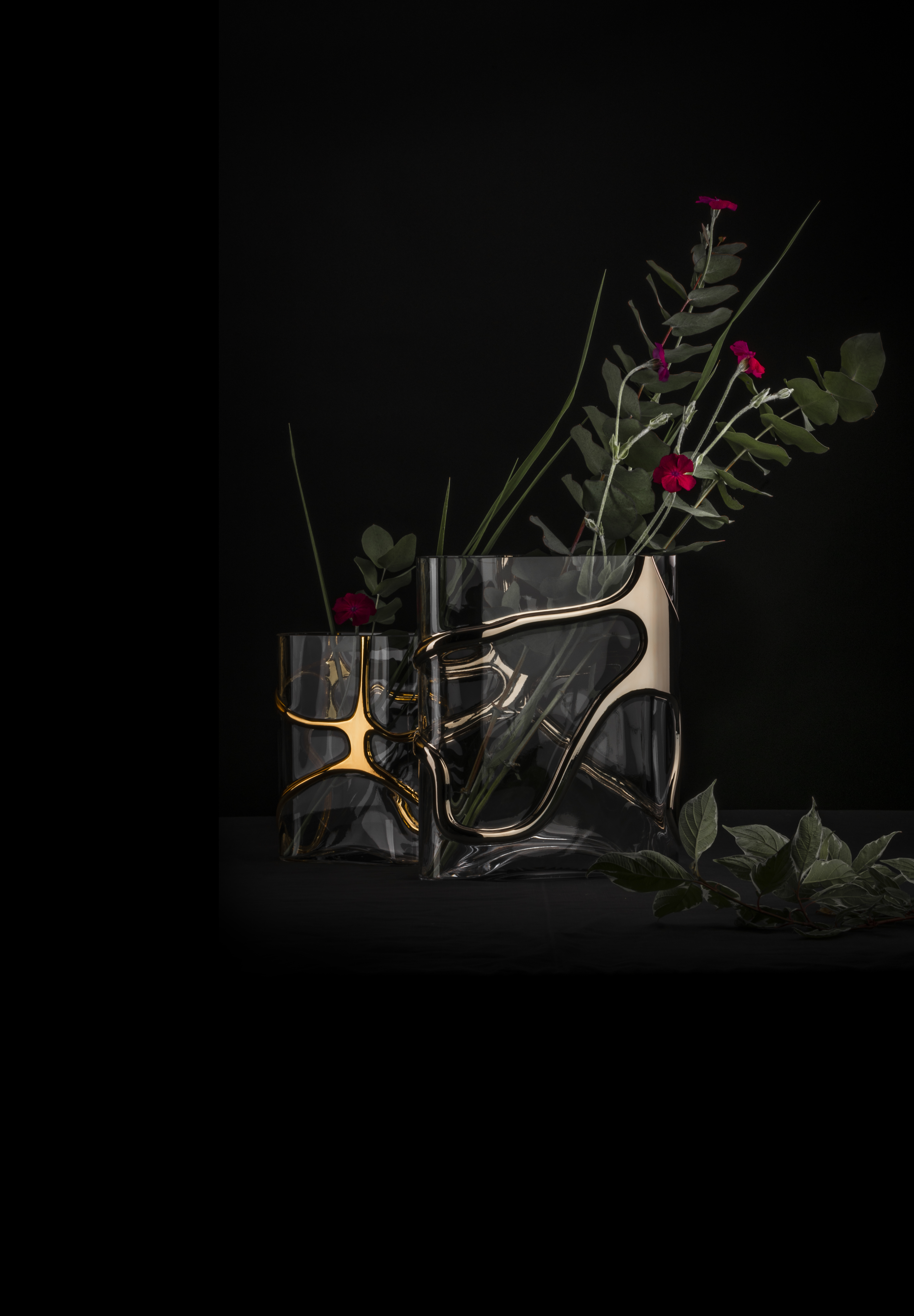 Vase in gold and silver against a black background