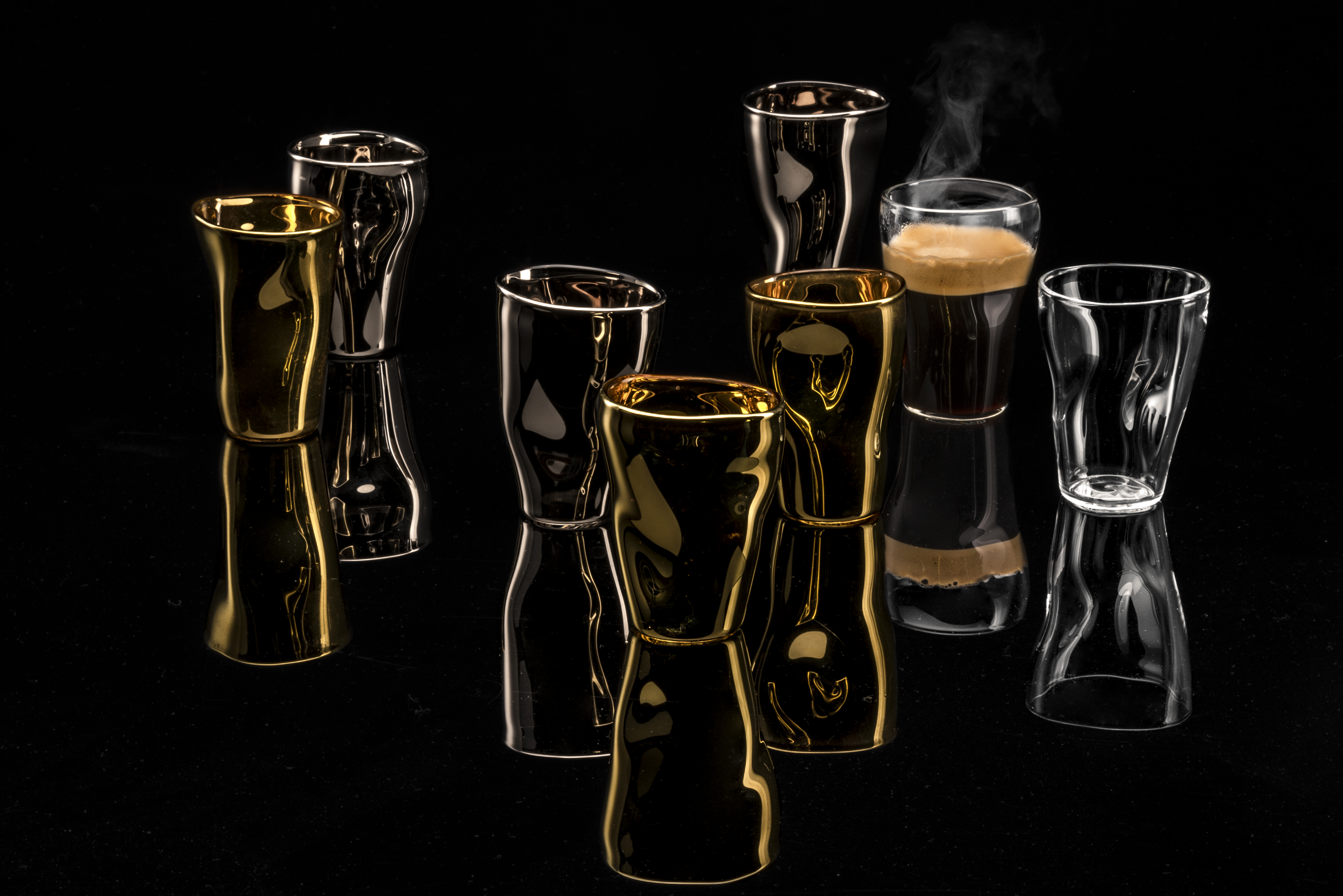 Various unik espresso cups against a black background
