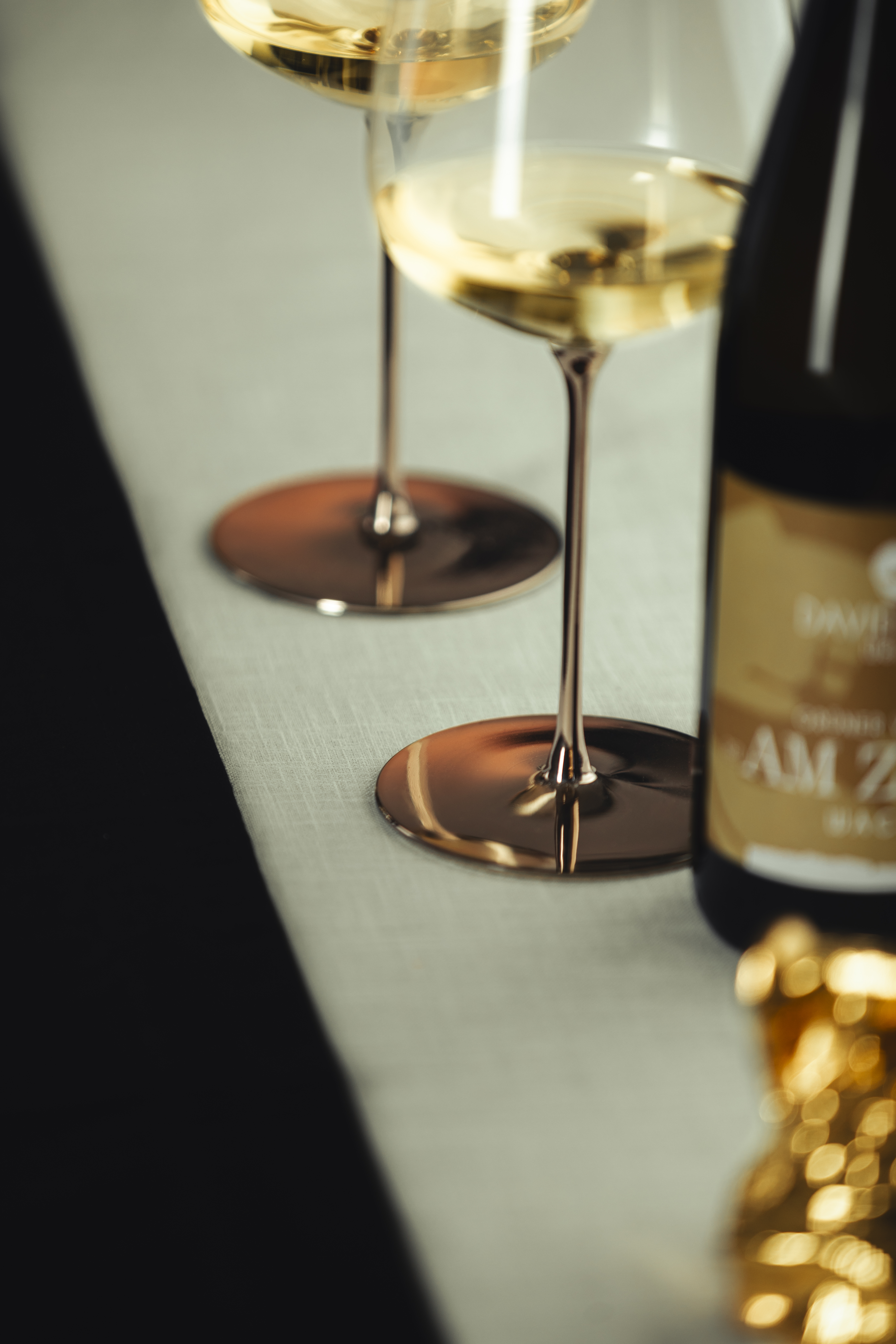 Close-up of platinum coating on two white wine glasses