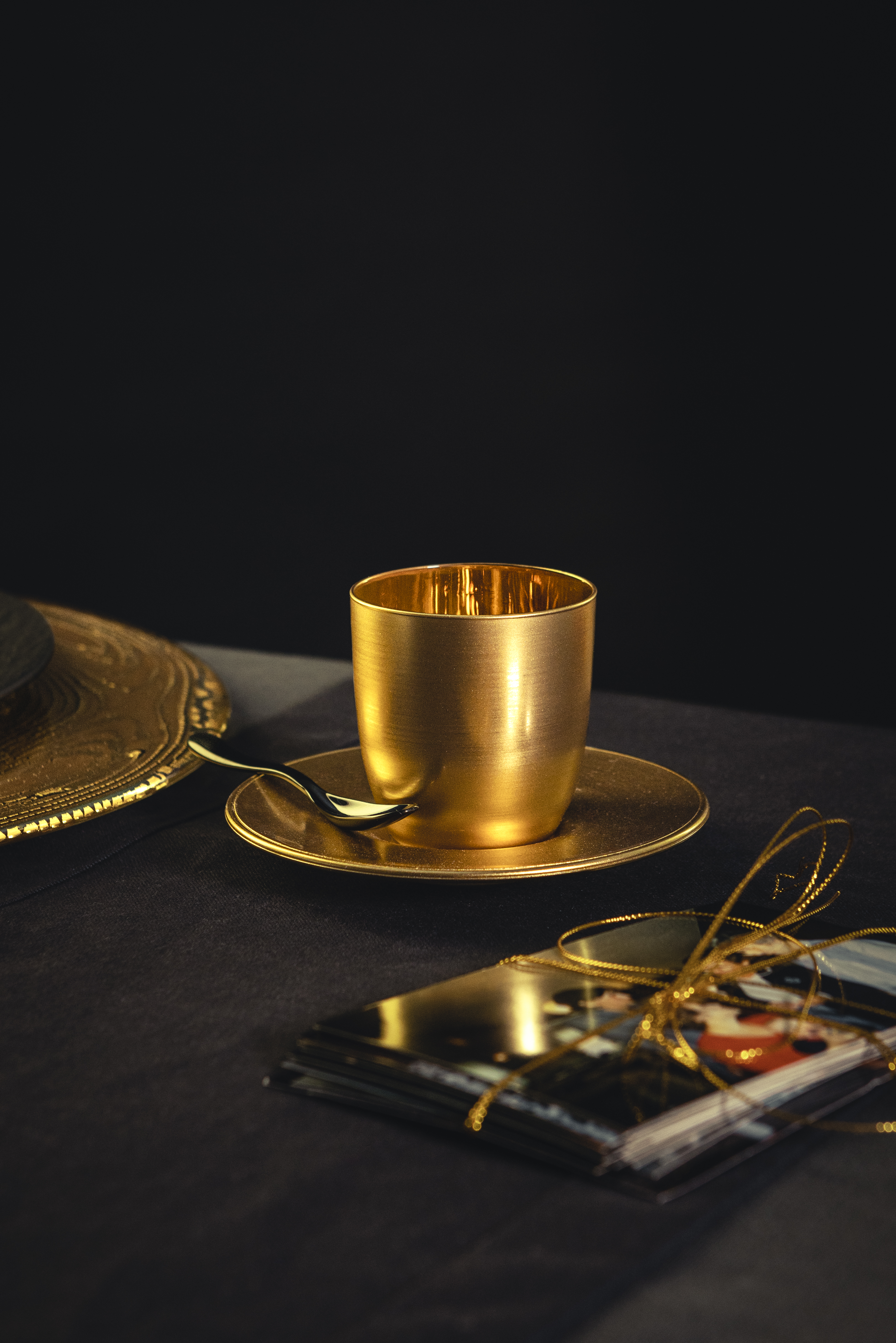 Gold espresso glass with small gift on table