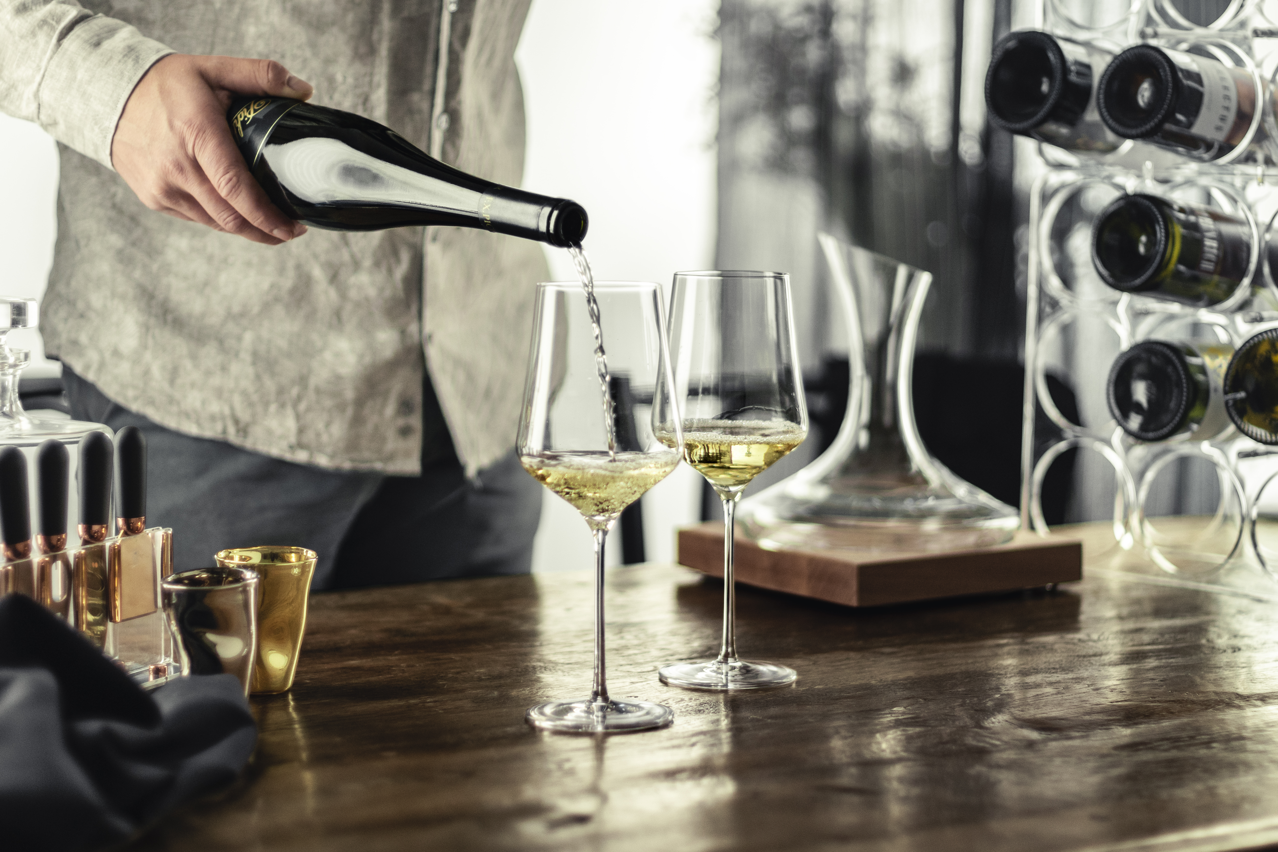 A person pouring wine into a wine glass