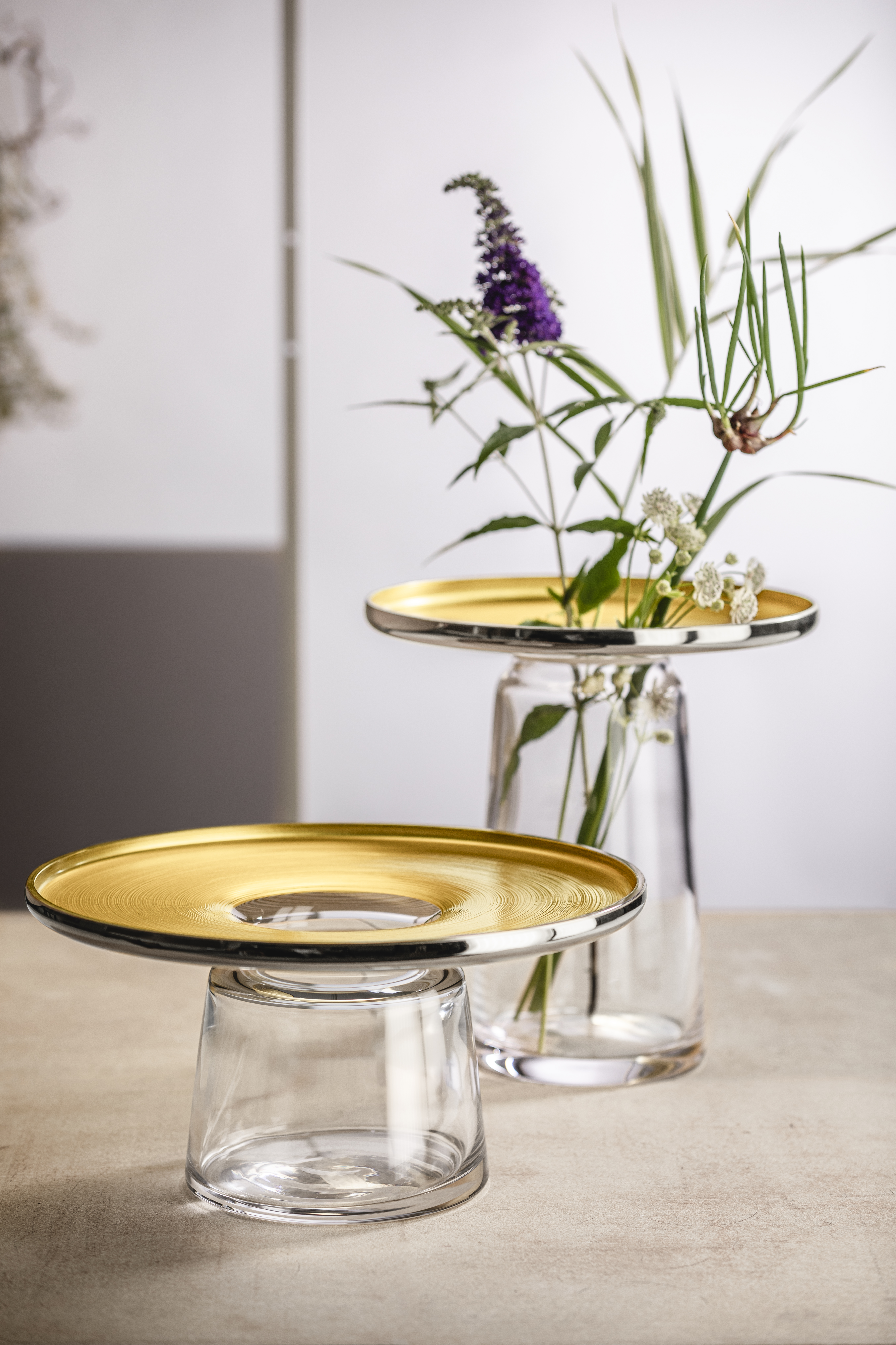 Two large golden vases on table