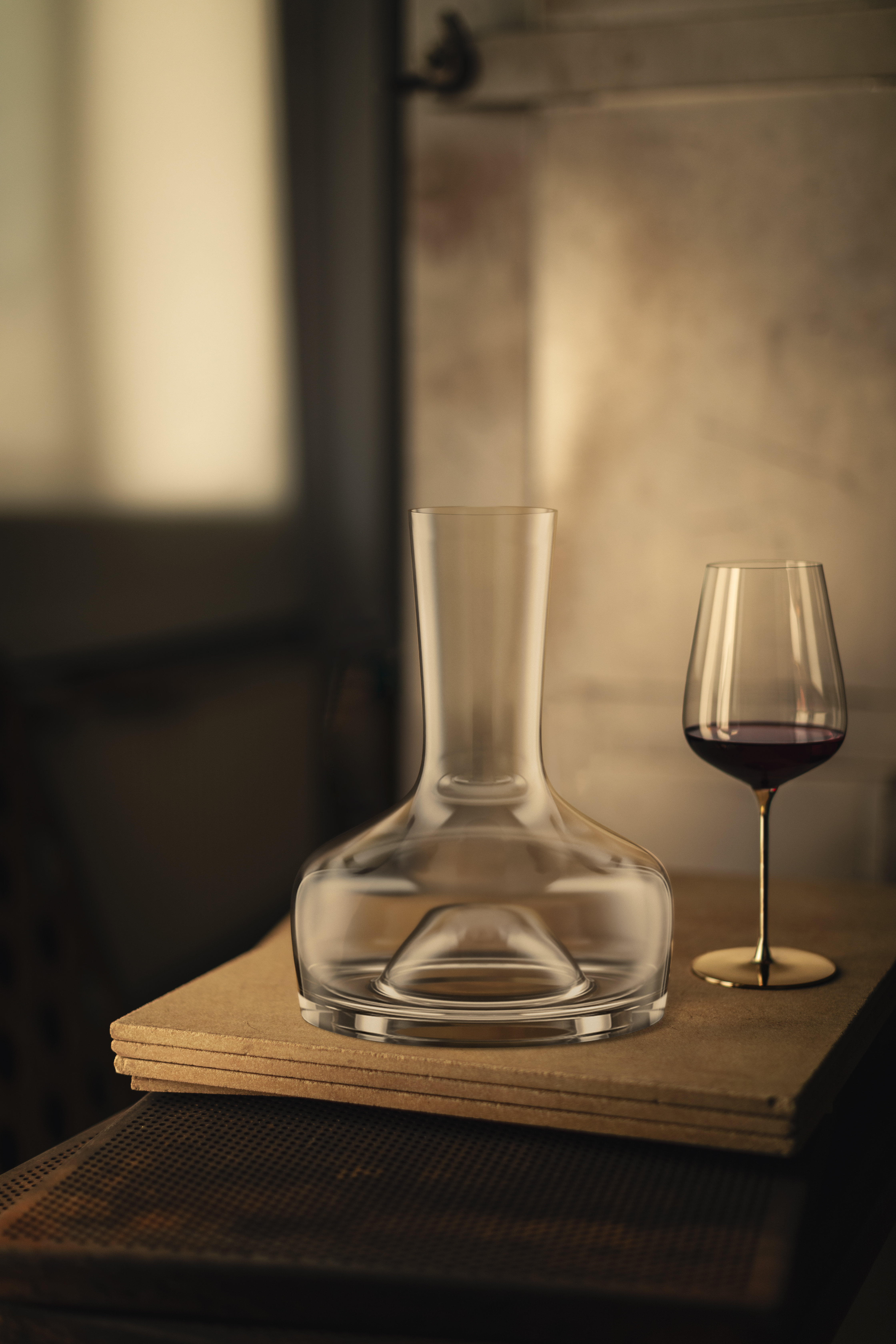 Decanter with a single wine glass on a table